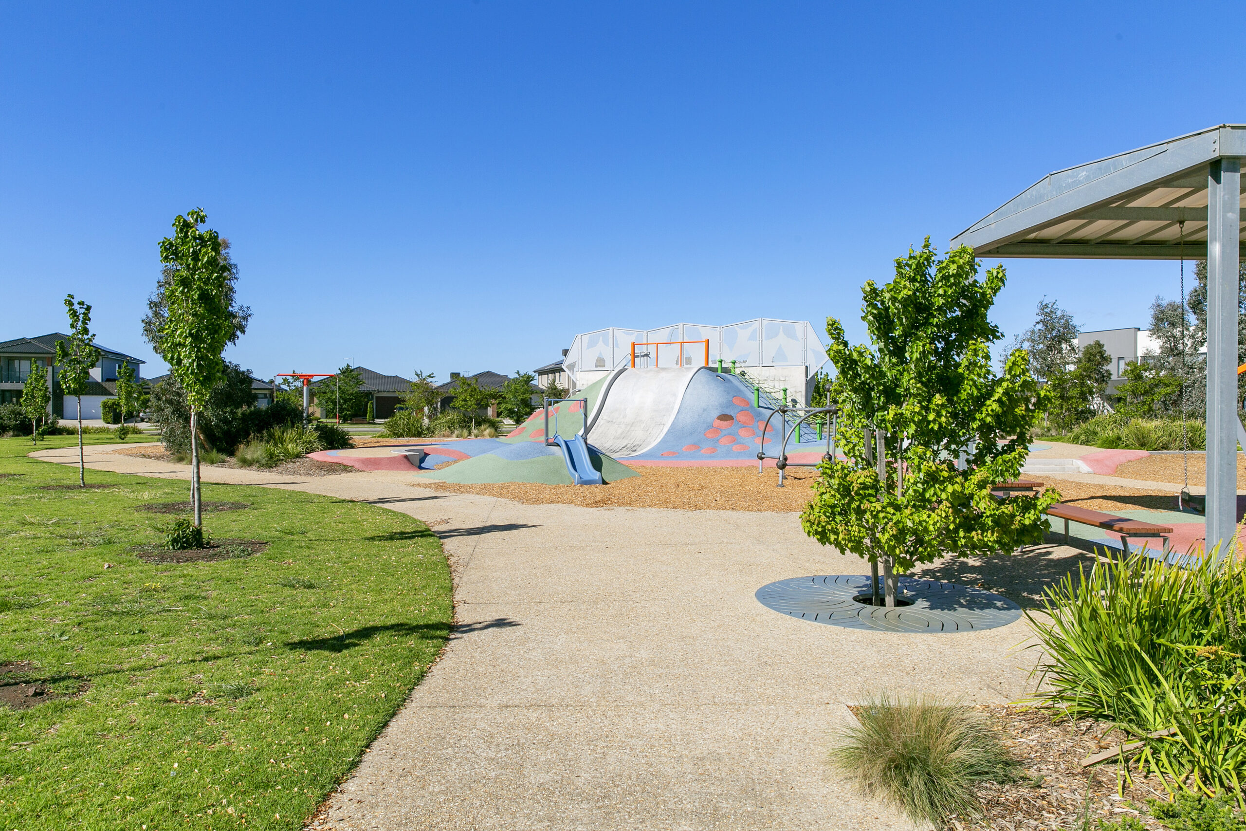 Children's playground surrounded by green open spaces, walking paths and landscaped gardens in Tarneit