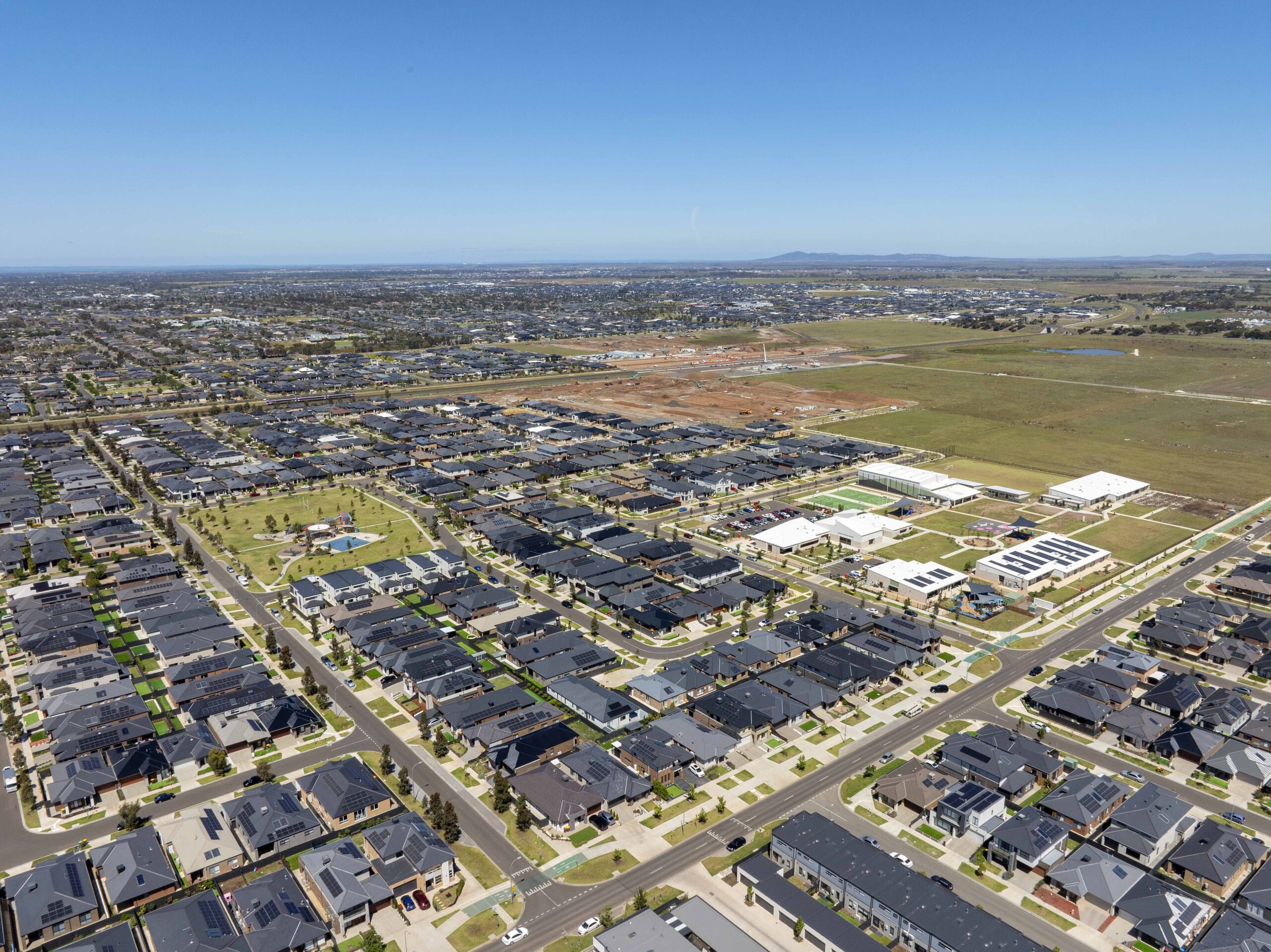 Aerial view of modern residential developments, local roads and surrounding open spaces in Melbourne's west