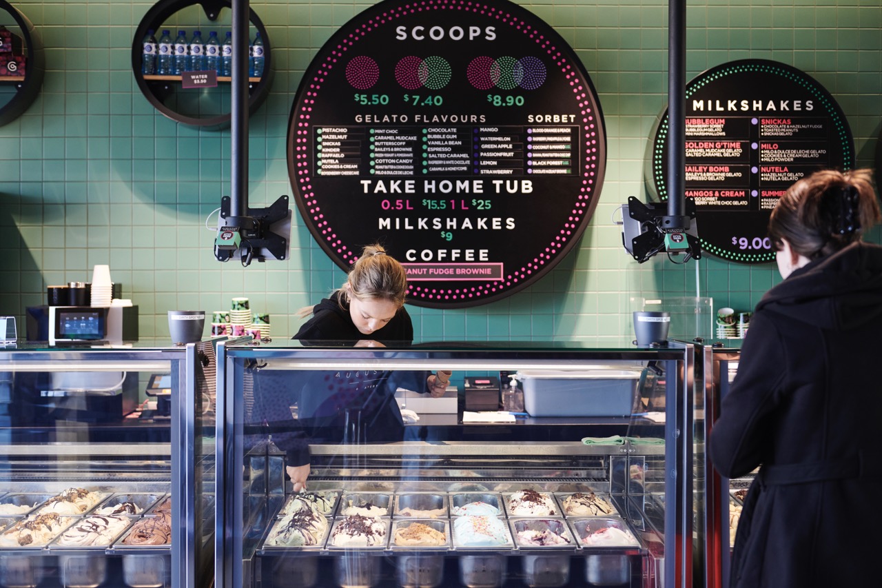 Local ice cream shop with display counter and customers, showcasing neighbourhood lifestyle amenities